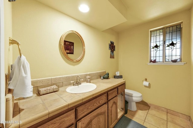 bathroom featuring toilet, vanity, and tile patterned flooring