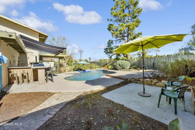 exterior space featuring exterior bar and a fenced in pool