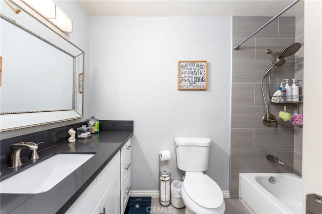 full bathroom with toilet, tiled shower / bath combo, and vanity