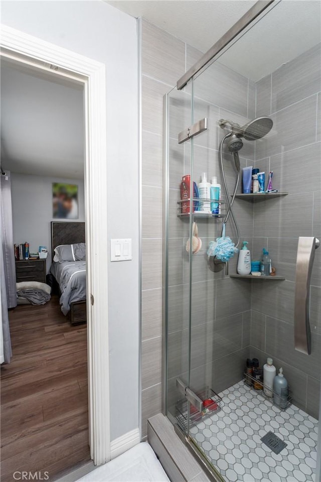 bathroom featuring walk in shower and wood-type flooring