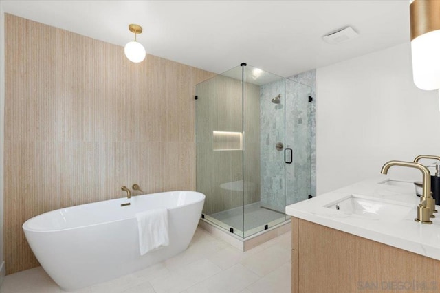 bathroom with separate shower and tub, vanity, and tile patterned floors