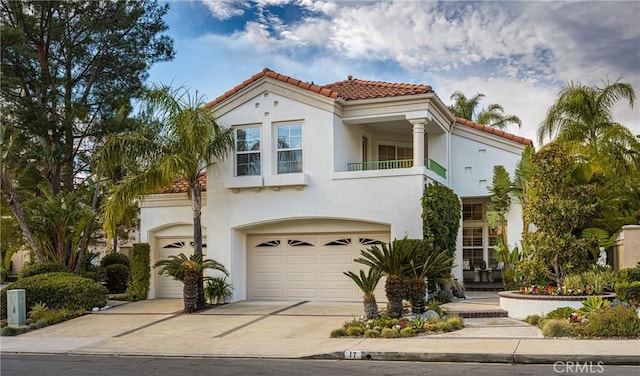 mediterranean / spanish-style house with a garage