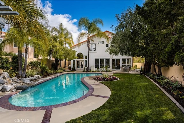 view of pool featuring a patio area and a lawn