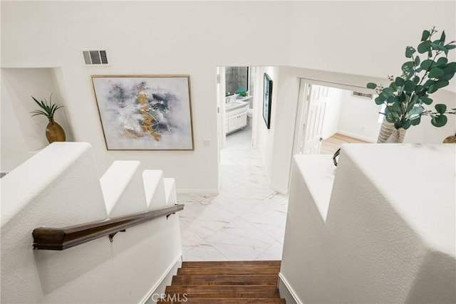 stairs featuring hardwood / wood-style floors