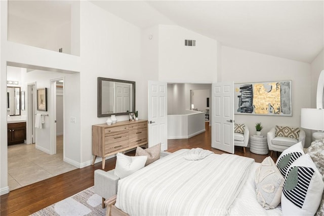 bedroom featuring hardwood / wood-style flooring and high vaulted ceiling