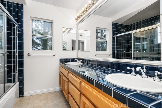 bathroom with enclosed tub / shower combo, vanity, and tile patterned flooring