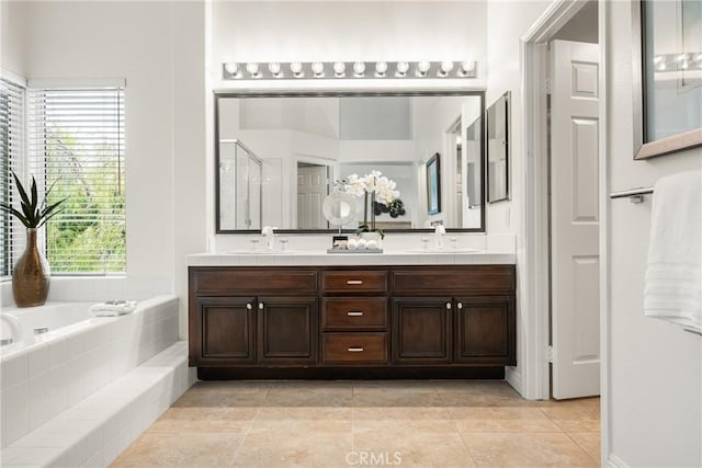 bathroom with tile patterned floors, vanity, and separate shower and tub