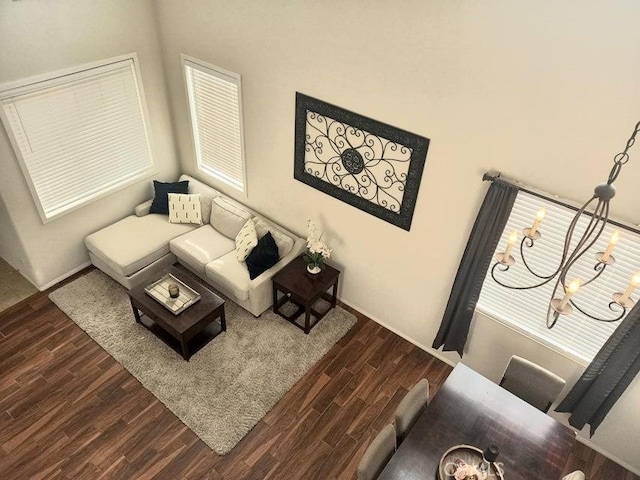 living room featuring dark hardwood / wood-style flooring and a chandelier