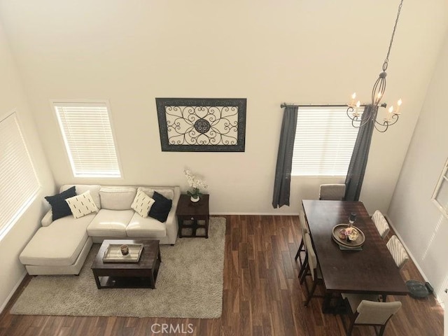 living room featuring dark hardwood / wood-style flooring and a notable chandelier