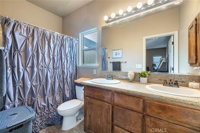 bathroom featuring toilet and vanity