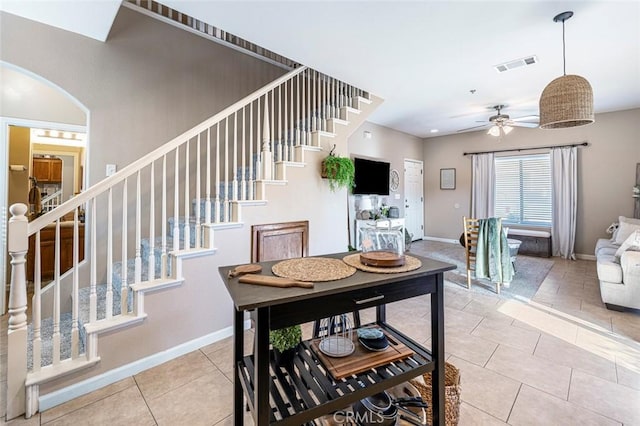 tiled dining space with ceiling fan