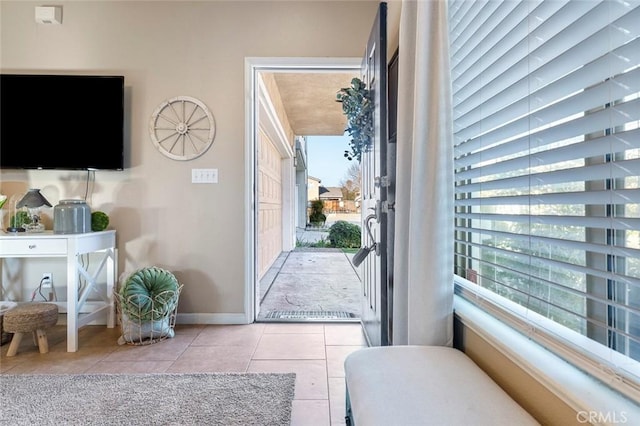 doorway featuring light tile patterned floors and plenty of natural light