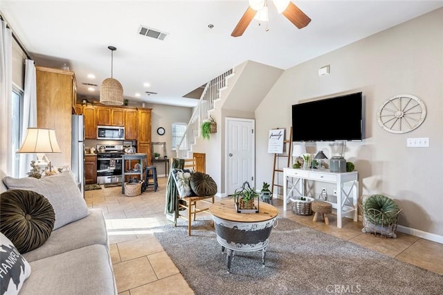 living room featuring ceiling fan and light tile patterned floors