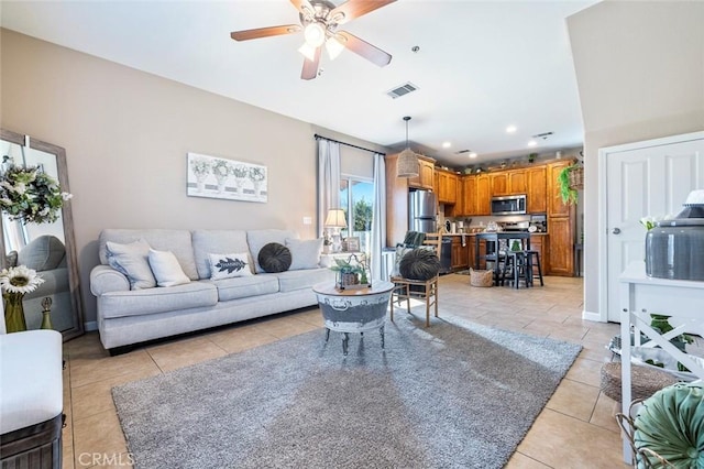 living room with ceiling fan and light tile patterned floors