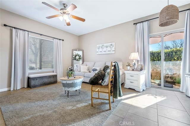 living room with ceiling fan and light tile patterned floors