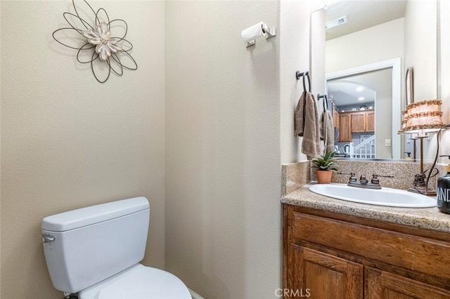 bathroom with toilet and vanity