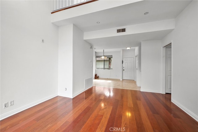 unfurnished living room featuring hardwood / wood-style floors