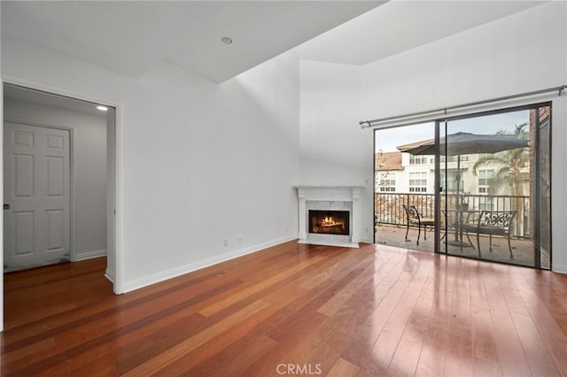 unfurnished living room with wood-type flooring and a fireplace