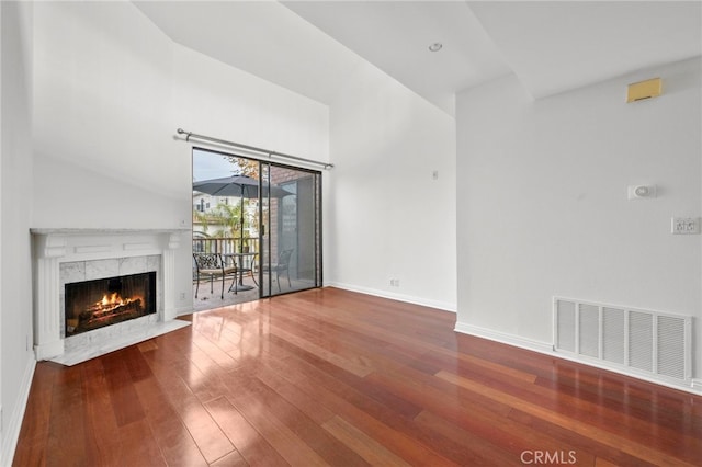 unfurnished living room featuring a premium fireplace and hardwood / wood-style flooring