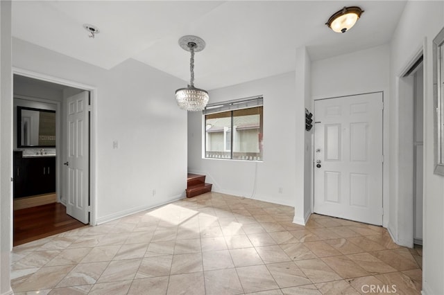 interior space with light tile patterned floors, a notable chandelier, and sink