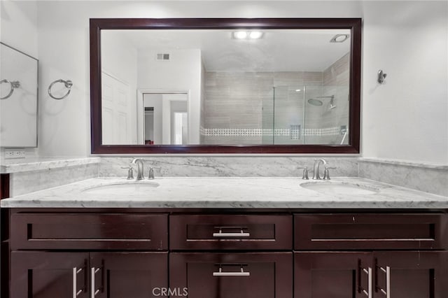 bathroom with vanity and an enclosed shower