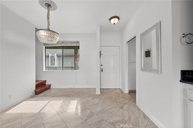 foyer featuring an inviting chandelier