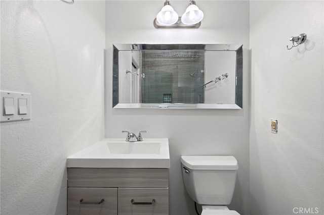 bathroom with toilet and vanity