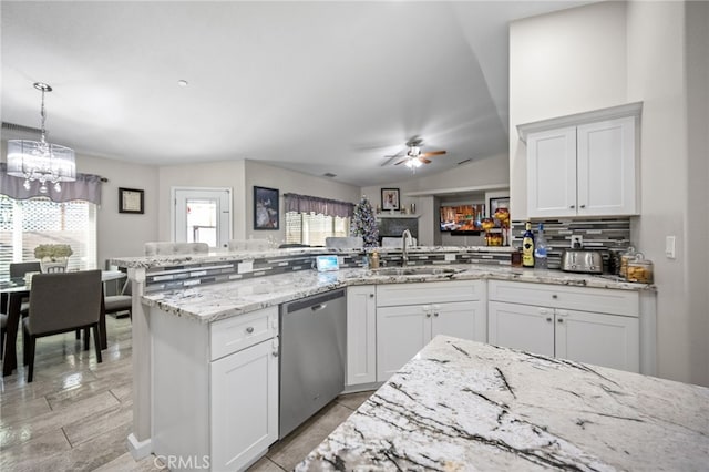 kitchen featuring sink, stainless steel dishwasher, ceiling fan, tasteful backsplash, and kitchen peninsula