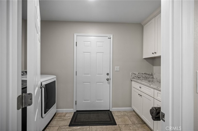 clothes washing area featuring cabinets and independent washer and dryer