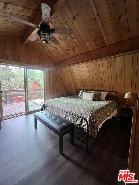 bedroom with ceiling fan, access to exterior, wood ceiling, and wood walls