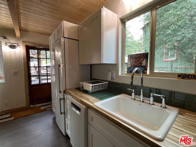 kitchen with dishwashing machine, sink, wooden ceiling, butcher block countertops, and beam ceiling