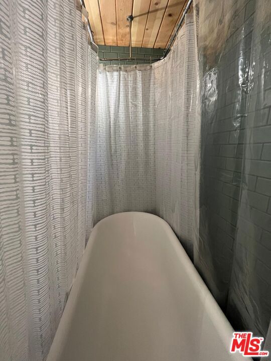 interior details with wooden ceiling and a tub to relax in