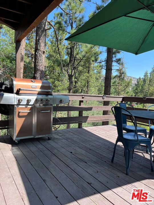 wooden terrace featuring area for grilling