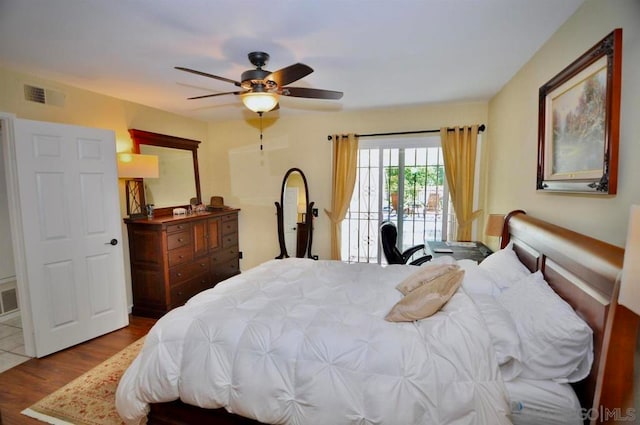 bedroom with ceiling fan, hardwood / wood-style floors, and access to outside