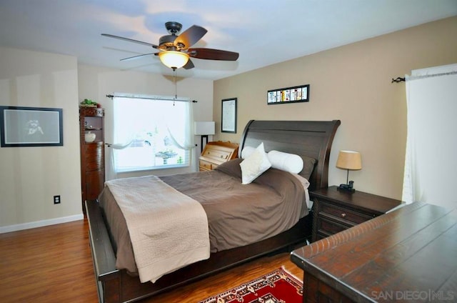 bedroom featuring ceiling fan and dark hardwood / wood-style floors