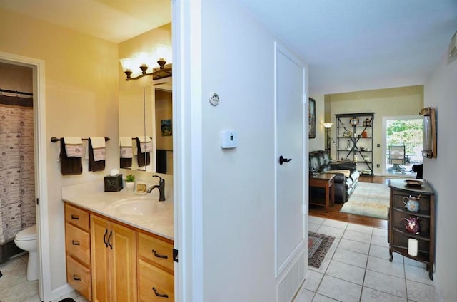 bathroom featuring toilet, vanity, and tile patterned floors