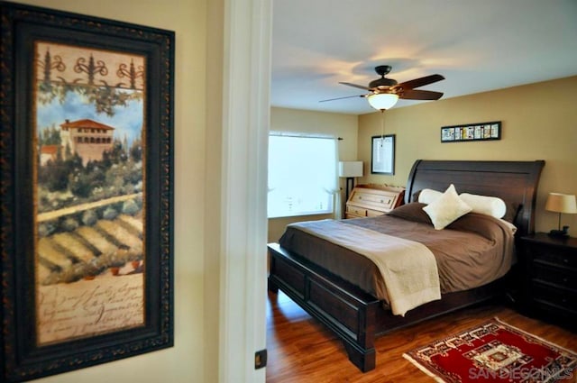 bedroom featuring ceiling fan and dark hardwood / wood-style flooring