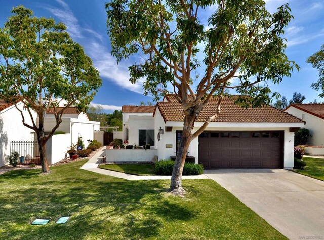 view of front of property with a front lawn and a garage