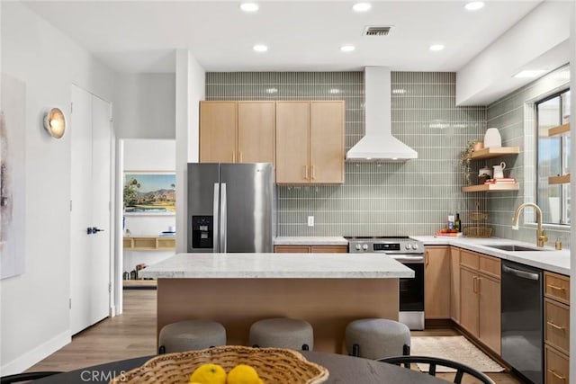 kitchen with custom exhaust hood, appliances with stainless steel finishes, decorative backsplash, light wood-type flooring, and sink