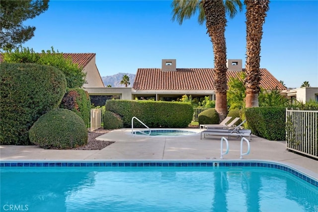 view of pool featuring a community hot tub and a patio