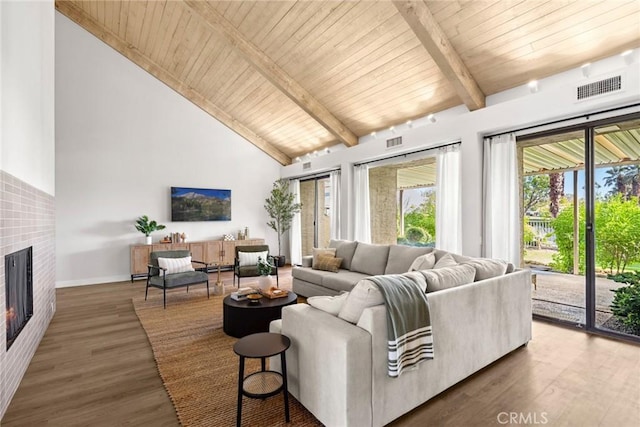 living room featuring beam ceiling, dark hardwood / wood-style floors, wood ceiling, and high vaulted ceiling