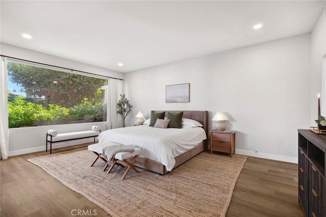 bedroom with dark hardwood / wood-style flooring