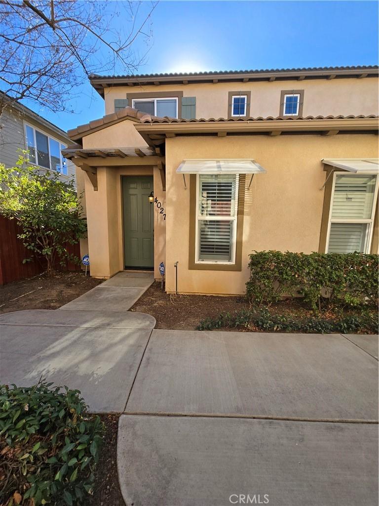 view of exterior entry with a patio