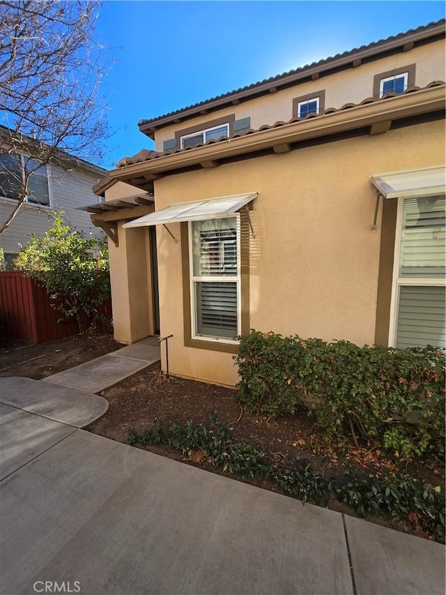 view of side of home featuring a patio