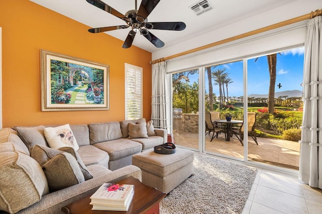 tiled living room with ceiling fan