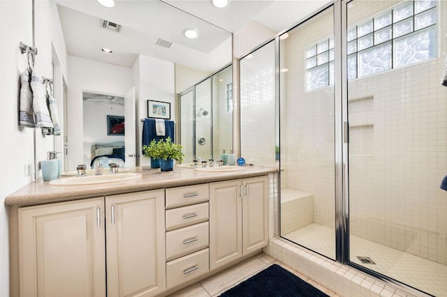 bathroom featuring vanity, tile patterned flooring, and an enclosed shower