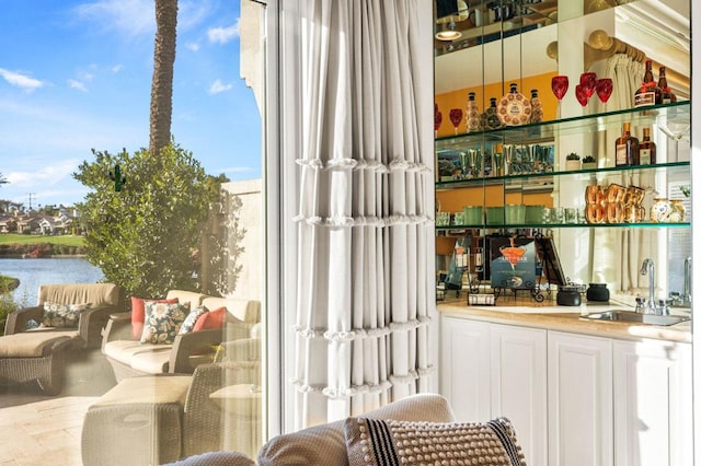 bar featuring a water view and sink