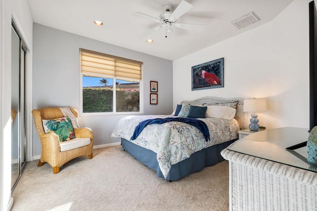 carpeted bedroom with ceiling fan and a closet