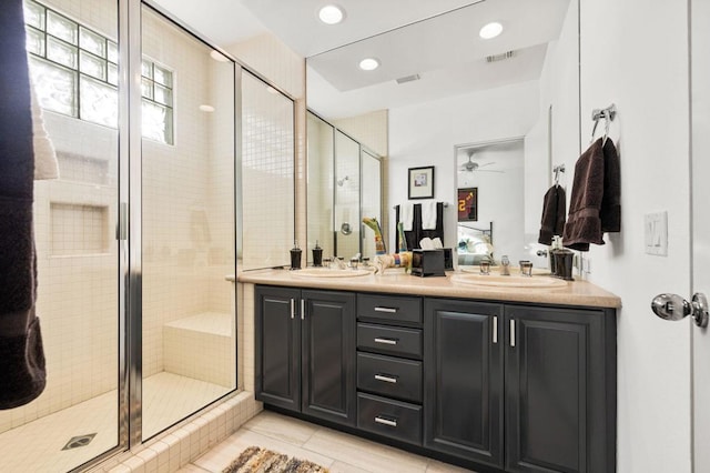 bathroom featuring ceiling fan, tile patterned floors, vanity, and an enclosed shower