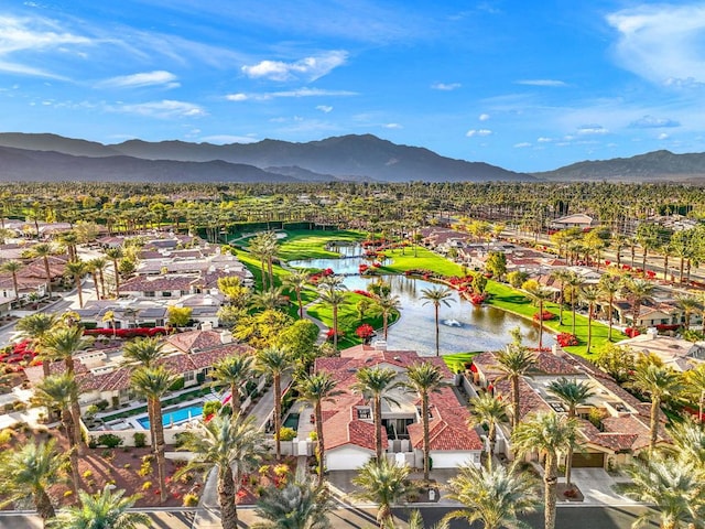 drone / aerial view featuring a water and mountain view